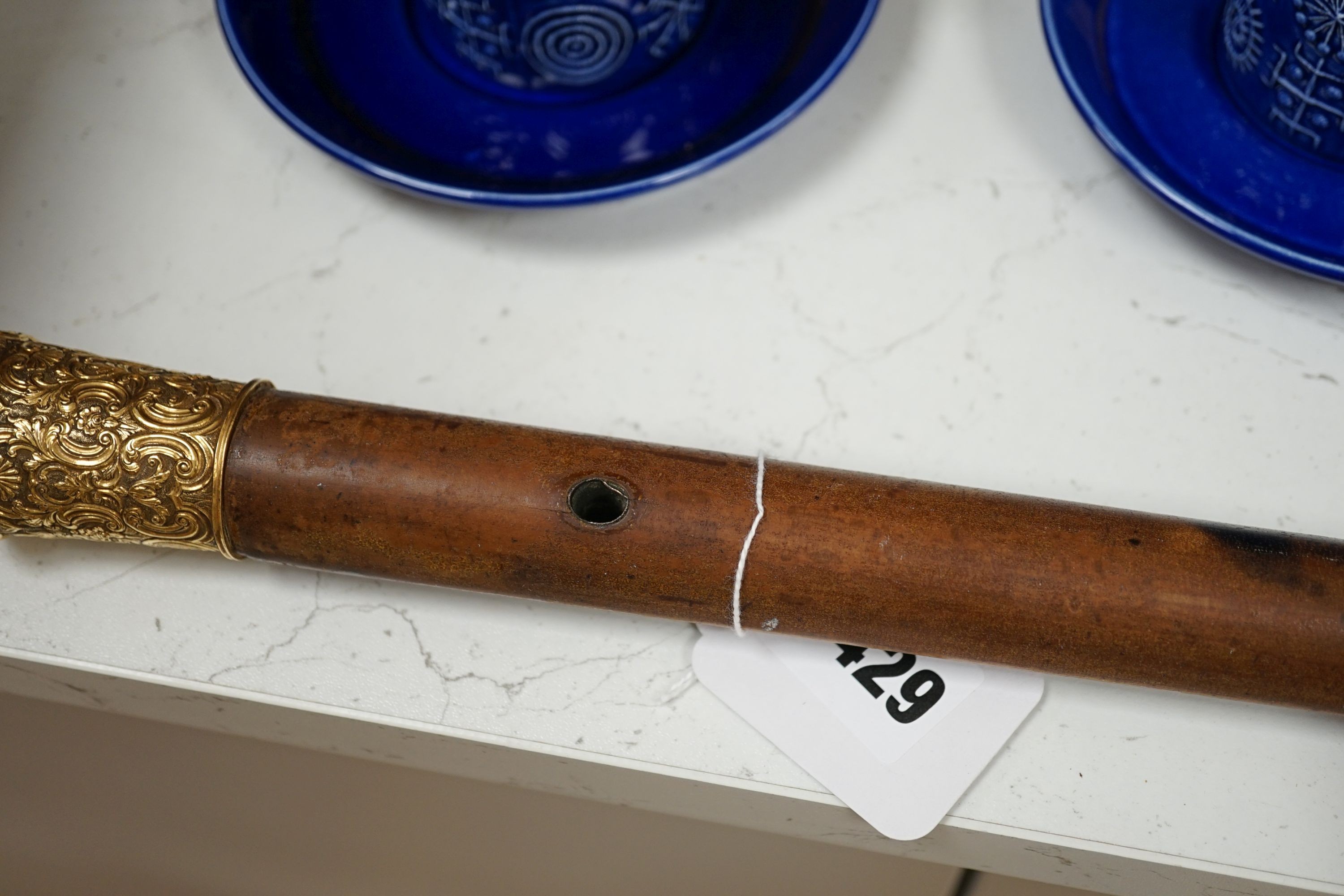 A 19th century malacca walking cane, with embossed yellow metal mount, 95cm.